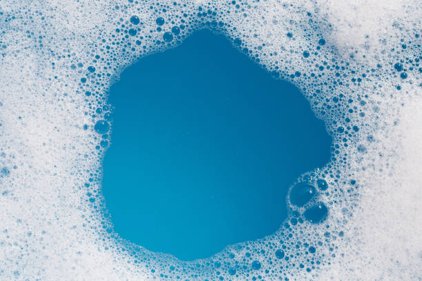 istock Detergent foam bubble on water. Blue background, Soap sud 1635065049