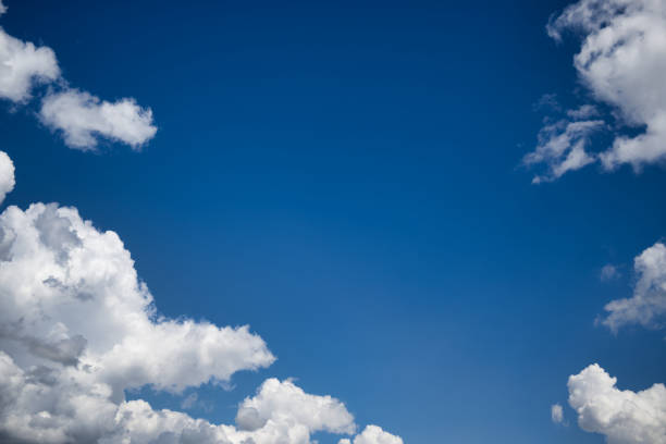 istock Blue sky with white cumulus clouds illuminated by daylight 1635088368