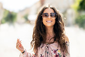 Happy young smiling woman in summer outfit with sunglasses. Outdoor portrait.