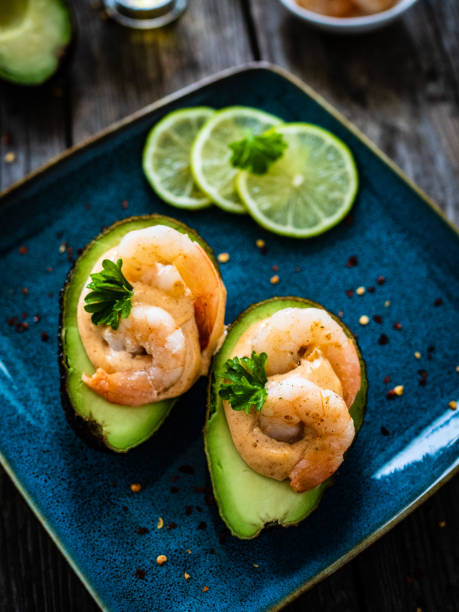 istock Prawns with avocado with dip on wooden background 1635110361
