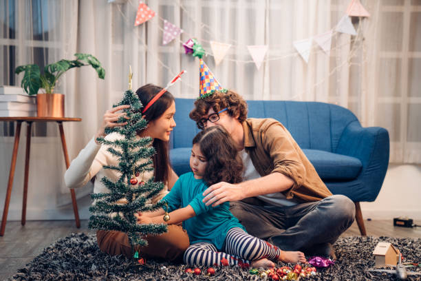 Happy lovely family father, mother and children celebrate Christmas and new year, light sparklers. stock photo