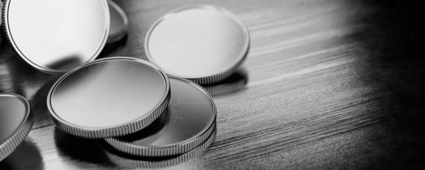 The concept of donations, savings. Silver coins without lying on a metal table. 3d render.