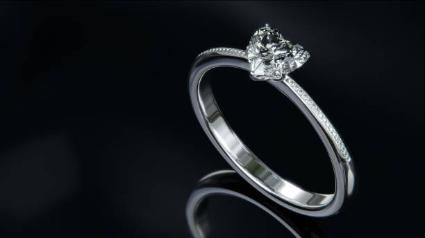 istock The platinum diamond ring sits on a shiny black glass surface. heart shaped diamond ring design with 3d rendering. 1635144826