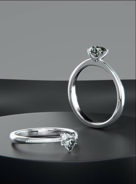 istock Two platinum diamond rings is placed on the black display stand, heart-shaped diamond rings design with 3D rendering. 1635145353