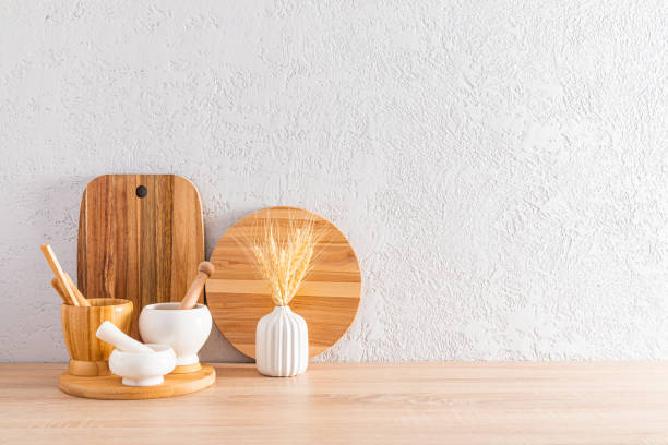 istock Modern kitchen countertop interior in a minimalist style. two wooden cutting boards and mortars with a pestle. front view 1635183479