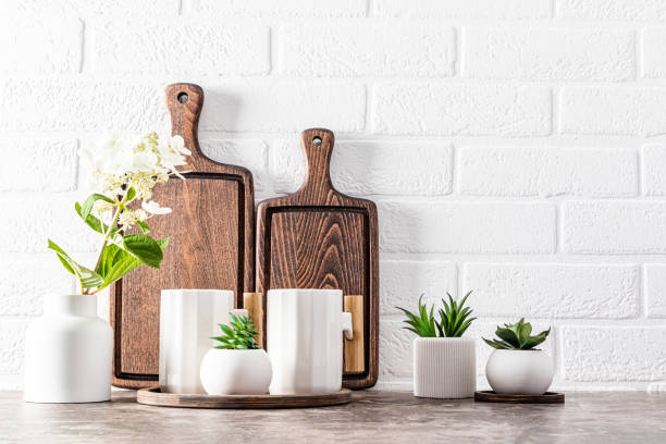 istock Stylish kitchen backdrop with dark wooden cutting boards and beautiful modern mugs. front view. Eco items. 1635183878