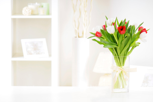 bouquet of tulips in a vase on a table in an interior room