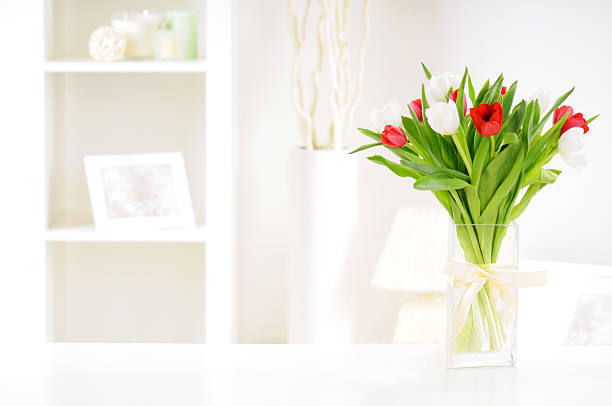 tulips bouquet of tulips in a vase on a table in an interior room white tulips stock pictures, royalty-free photos & images