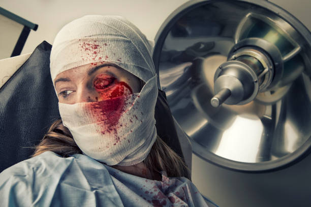 Torture Victim in shock from loosing an eye Torture Victim in shock from loosing an eye. This stock image has a horizontal composition. hospital gown open stock pictures, royalty-free photos & images