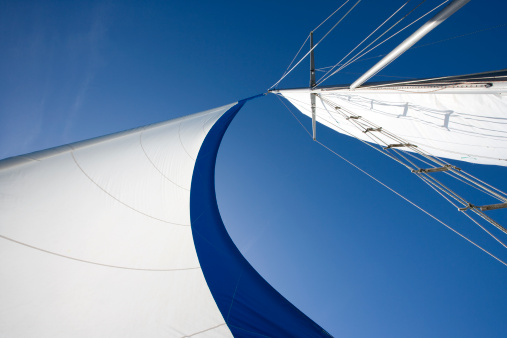 Wind fills sails on a clear day.