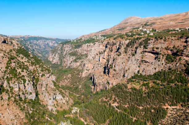 The historic and narrow Qadisha Valley in Lebanon. It is home to a large Christian population and several churches and monasteries. One church is visible on top of the ridge in the upper right.