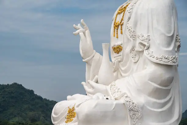 Photo of Close up hand of large statue of Guanyin showing Abhaya Mudra gesture.