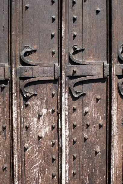 Photo of Detail in close up on the medieval door of the cathedral at Dinant