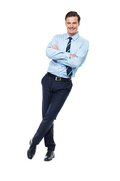 Confident in his business prowess A full length studio shot of a confident looking young businessman leaning against a wall with his arms crossed leaning stock pictures, royalty-free photos & images