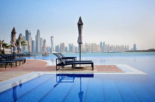 Holiday resort by the pool on the Palm Island in Dubai with a view of Jumeirah