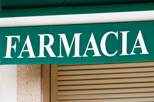 Pharmacy sign in spanish language, awning . Santiago de Compostela, Galicia, Spain.