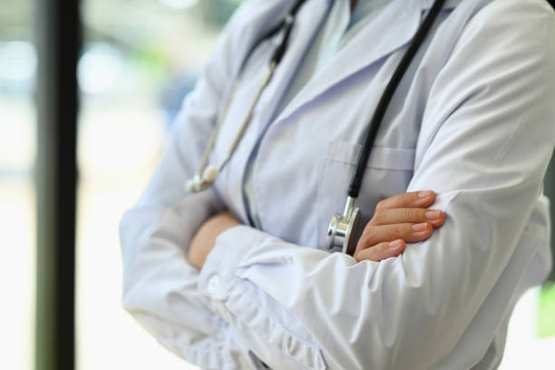 istock Unrecognizable general practitioner standing with arms crossed standing near window in hospital 1635251716