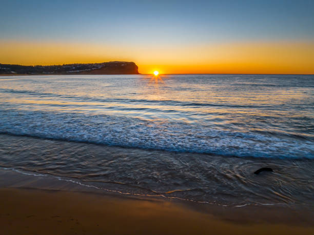 istock Clear skies and flat surf sunrise seascape 1635257072