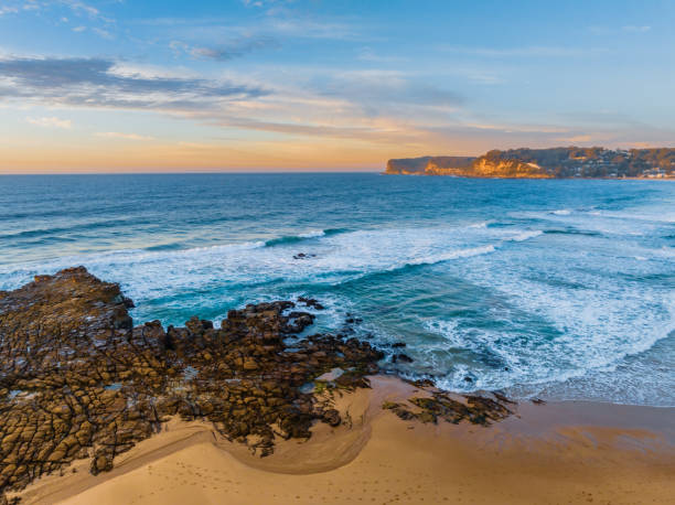 istock Ocean sunrise with rock platform and clouds 1635258655