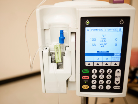 Photo of IV drip intravenous infusion pump medical equipment in a hospital room