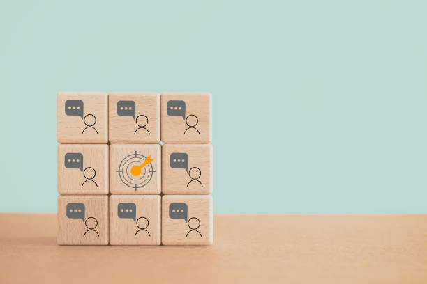 istock Customer feedback to improve business growth concept. Dartboard and man with chat icon on wooden cube blocks on grunge green background including copy space 1635271287