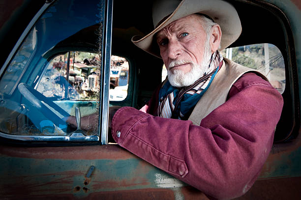 istock Cowboy in an old truck 163529362