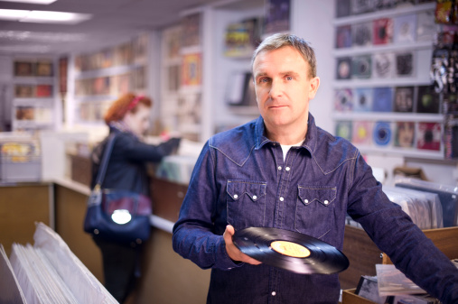man searches the second hand record shop .