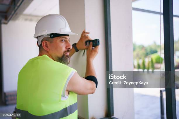 Laser Field Engineer Construction Engineer Using A Laser Level To Measure The Distance Stock ...