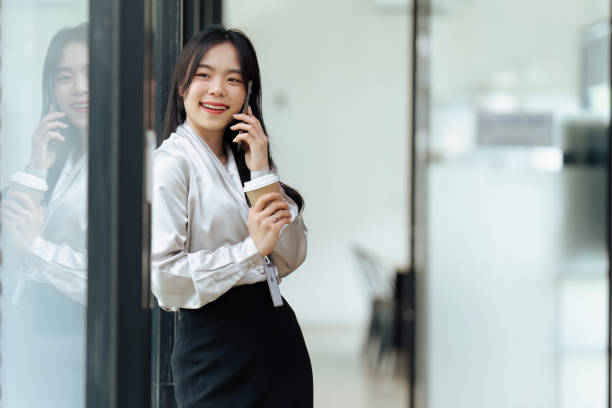 istock female entrepreneur talking on the phone while coffee break 1635330918