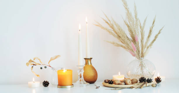 istock autumn home decorations with burning candles 1635339214