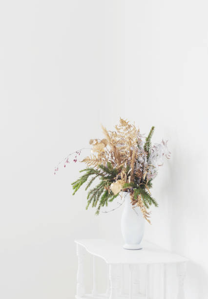 istock christmas bouquet in white vase on white background 1635339304