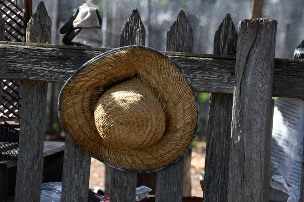 Farmers work hat on old rustic wooden fence