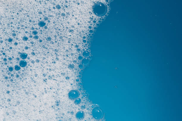 istock Detergent foam bubble on water. Blue background, Soap sud 1635348548