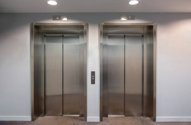 istock Elevators lobby, Stainless steel lifts with closed doors front view. 1635369119