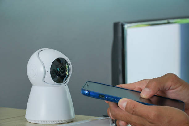 istock asia men using smart phone connecting to CCTV security at home. 1635396686