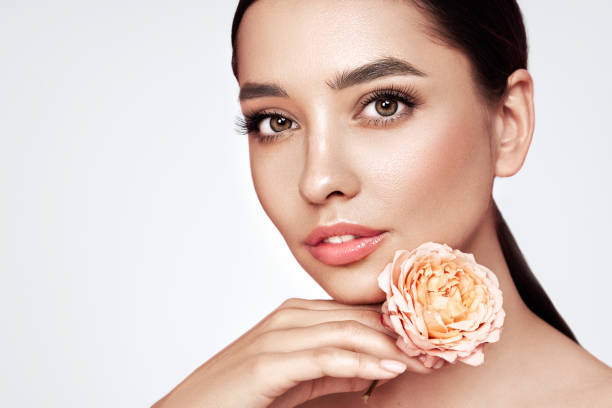 istock Beautiful young woman a rose flower 1635420358