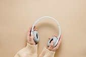 Woman hold wireless headphones top view.