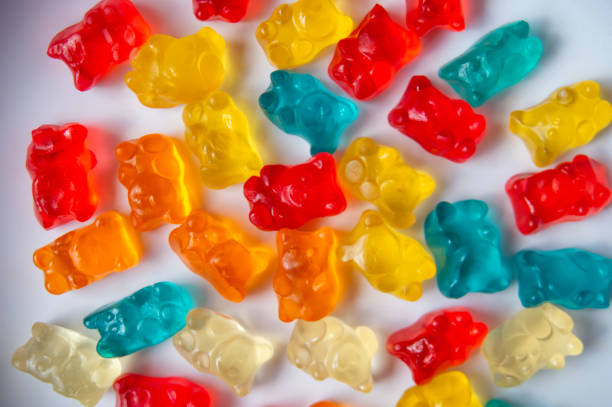 istock Sweet jelly bear candy on a white plate with a wood pattern background 1635440838