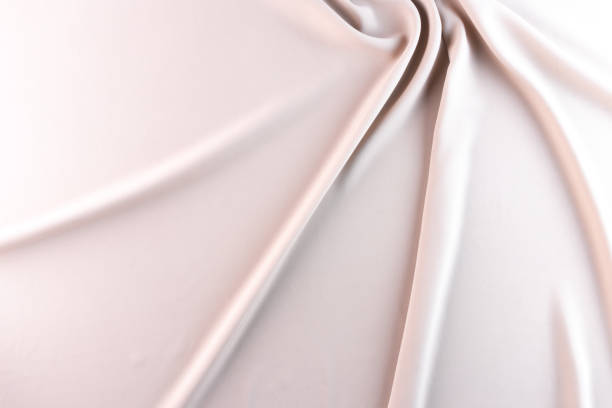 istock Abstract silk background pale pink fabric fancy liquid waves. Bright color abstract fabric texture background. Soft elegant wave fabric. Elegant folds of satin, silk and fine cotton, flat lay 1635459392