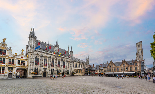 Bruges, Belgium - June 27, 2023: City hall of the historic town Bruges. The city's most famous medieval buildings  with restaurants, cafes and shops in summer.