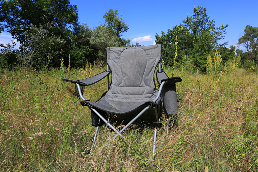 camping chair on a green meadow on a sunny day