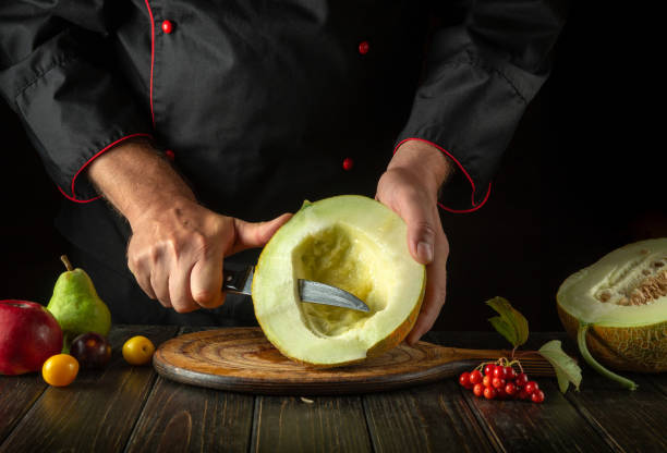 istock The chef cuts a ripe melon on a cutting board with a knife. Working environment with fruits on the restaurant kitchen table 1635473925