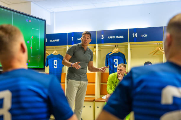 istock Coach instructing football players 1635478290