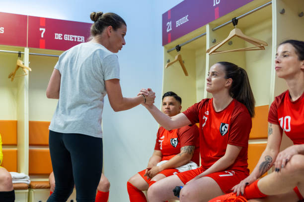 istock Coach instructing female football players 1635480971