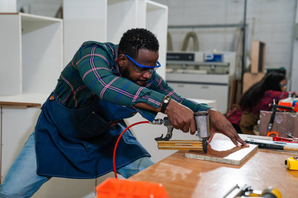 istock Afro American craftsman working as carpenter in a carpentry workshop. 1635490067