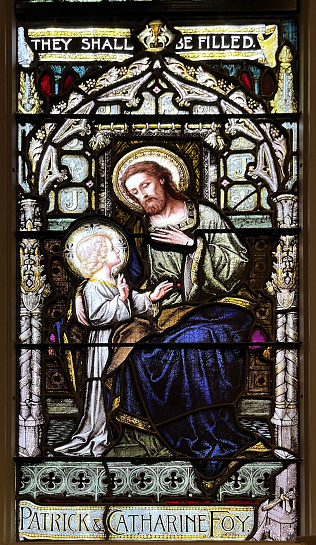 Stained glass window depicting the Child Jesus and St Joseph, St Michael's Cathedral. Toronto, Ontario, Canada. 2023-01-10