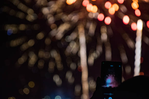 istock photo of fireworks with mobile phone and background with bokhe effect 1635492902
