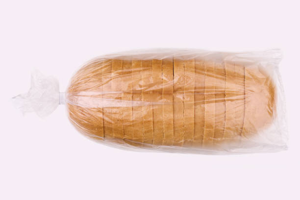 istock Sliced loaf of wheat bread isolated on white. Sliced bread in a plastic bag. 1635494803