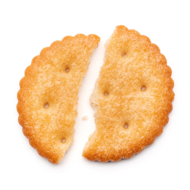 istock Healthy whole wheat cracker on white background. Stack of Saltine crackers isolated on white background. Round crackers. 1635497468