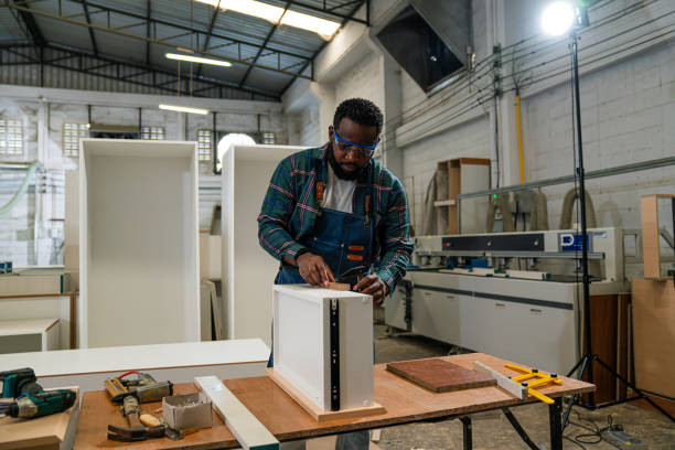 istock Afro American craftsman working as carpenter in a carpentry workshop. 1635502361